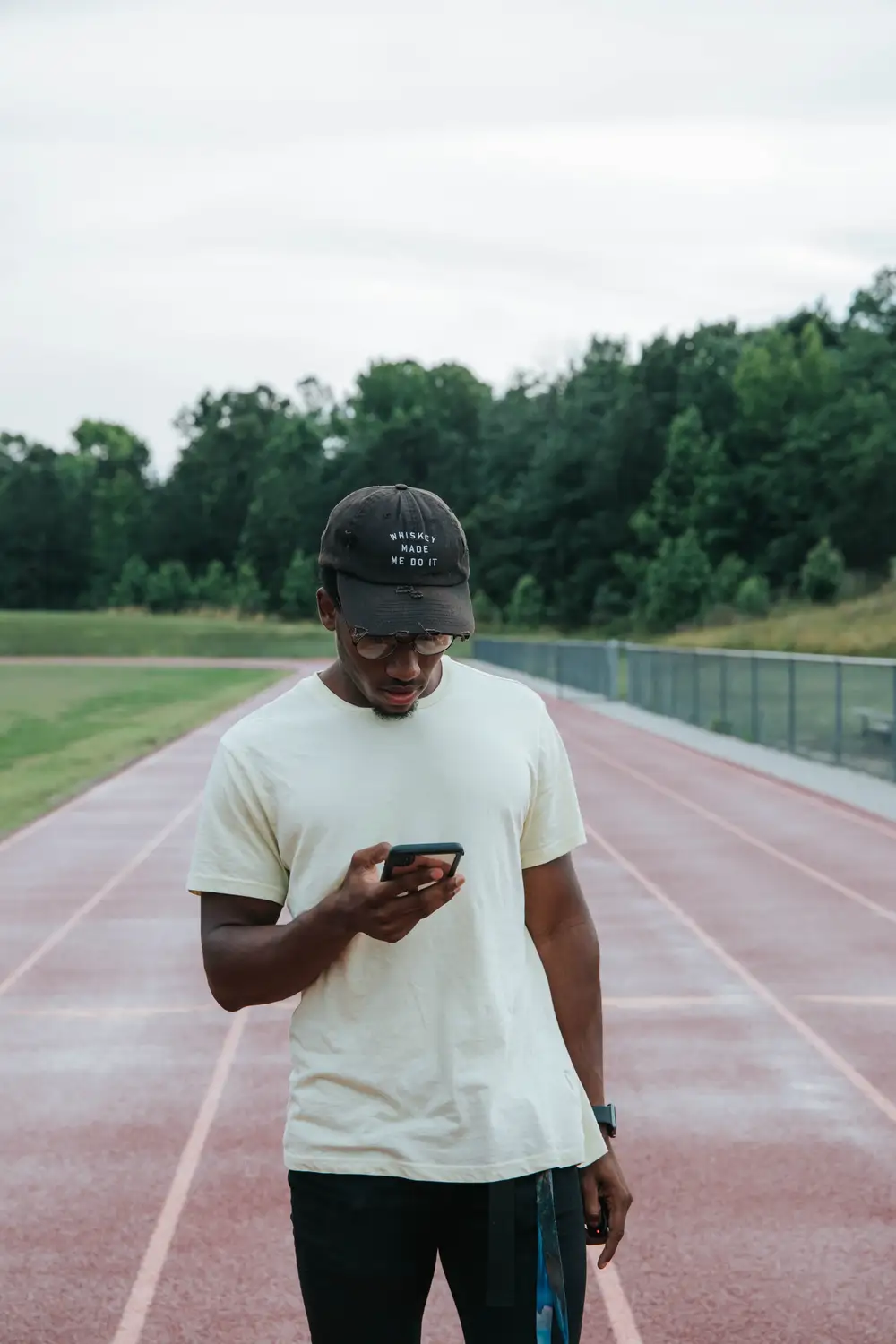 Young man with a phone on the track