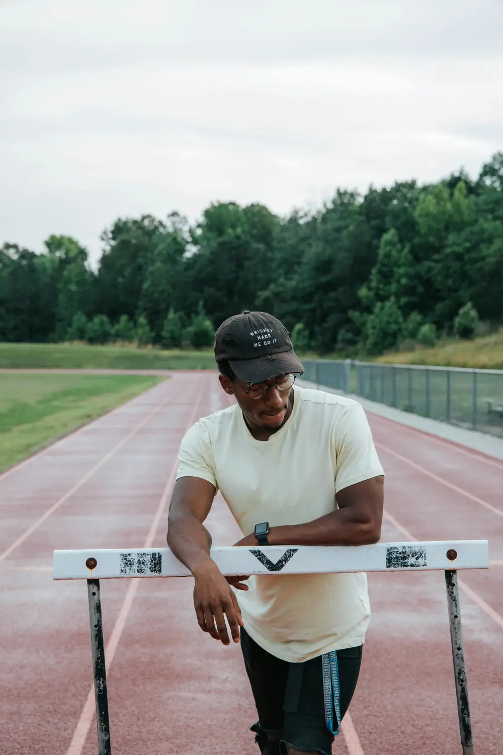 Young black man resting on a hurdle