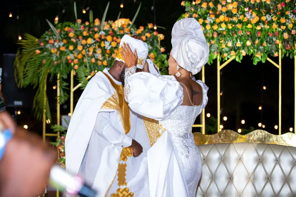 Bride putting on Groom cap