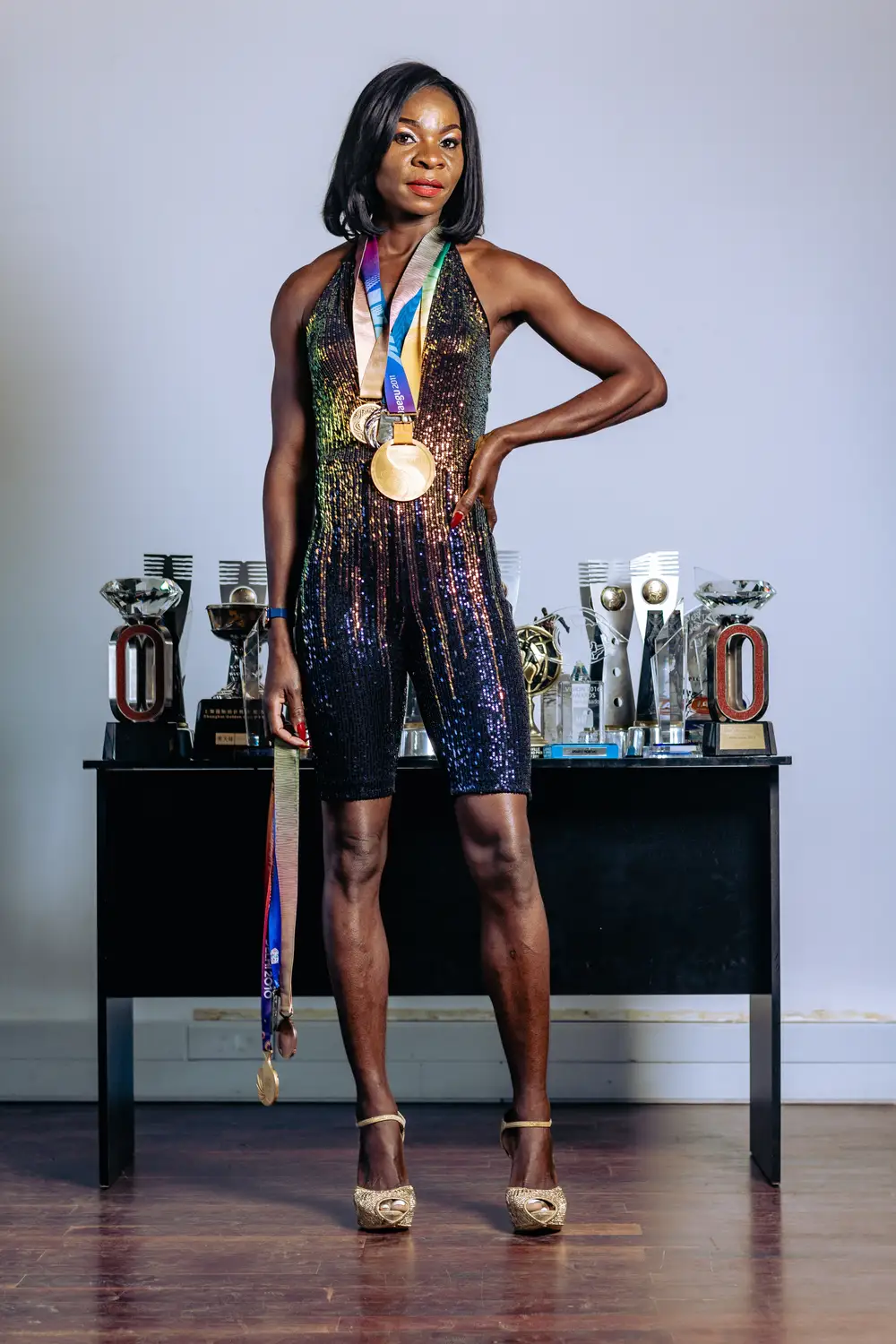 a woman holding multiple awards