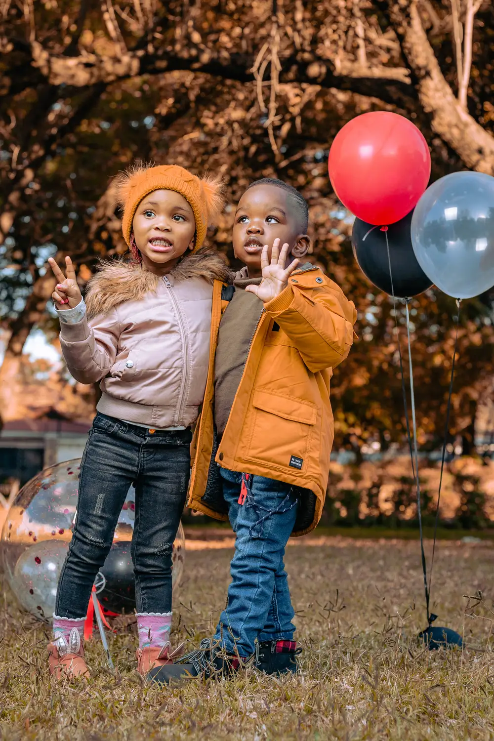 little boy and girl posing for a birthday picture