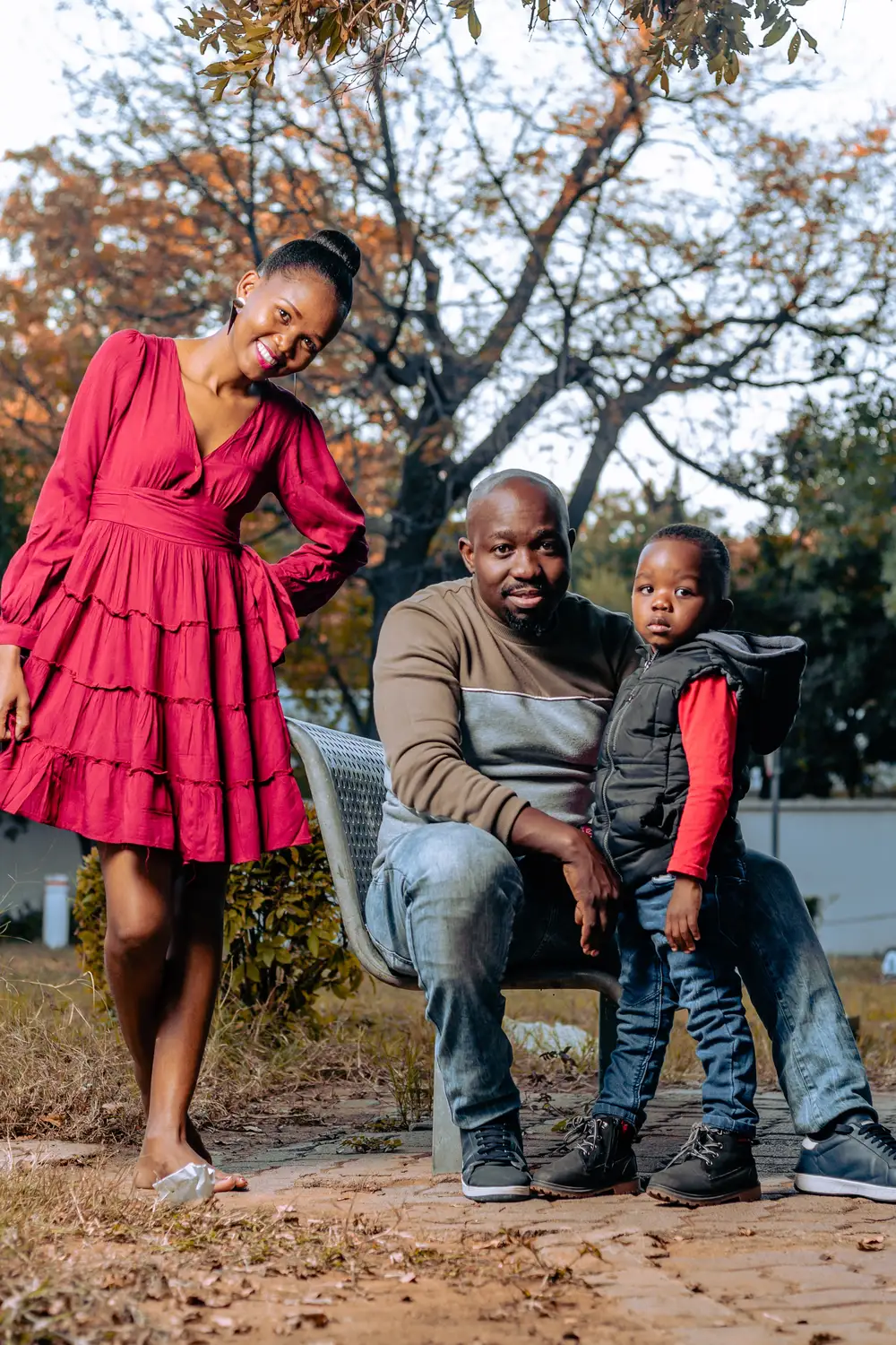 little boy standing with his parents