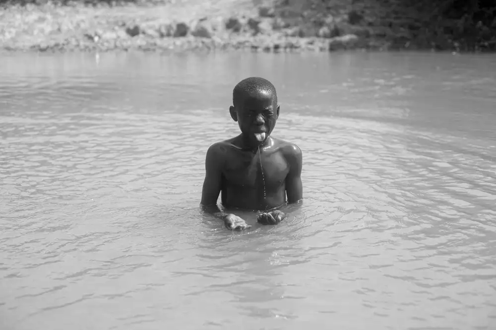 Boy taking his bath in a river