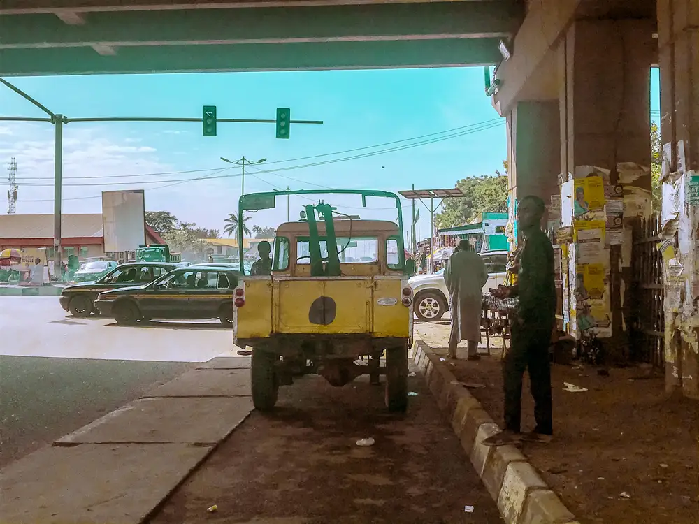 Man standing beside an old car