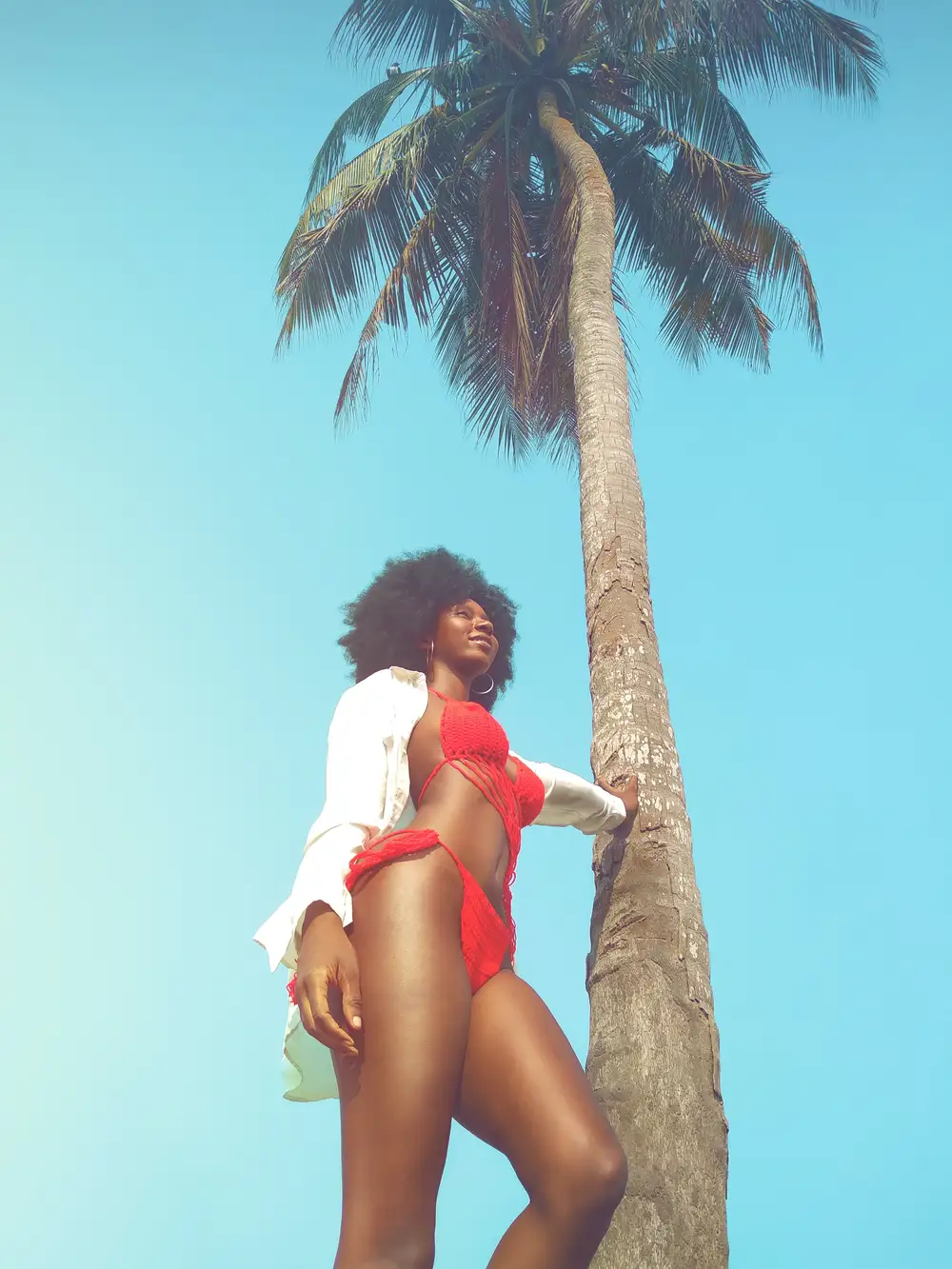 woman with swimsuit under a palm tree