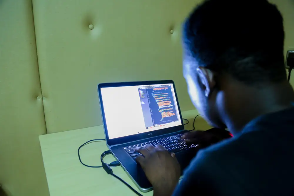 man coding on his computer