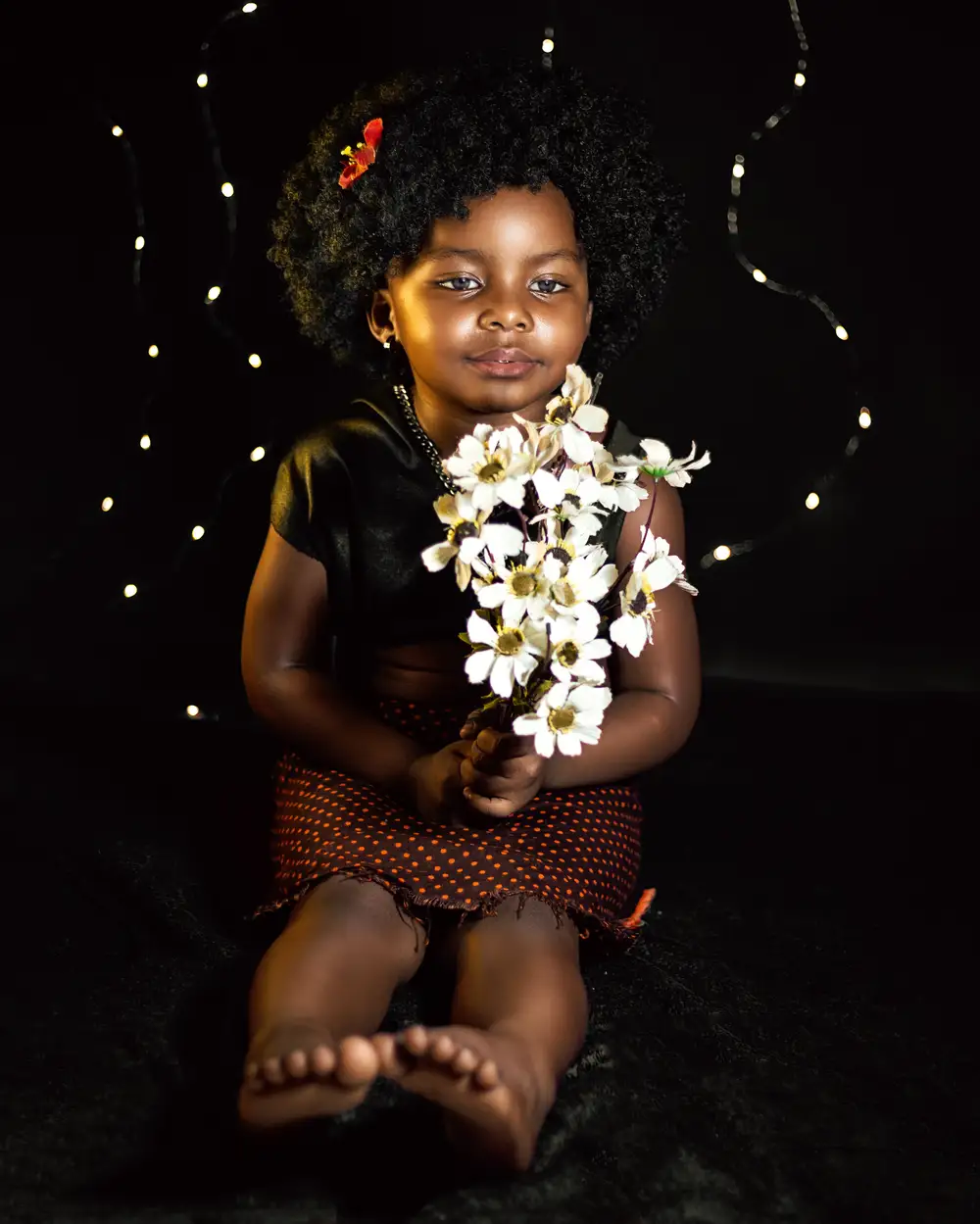 Black child holding flowers