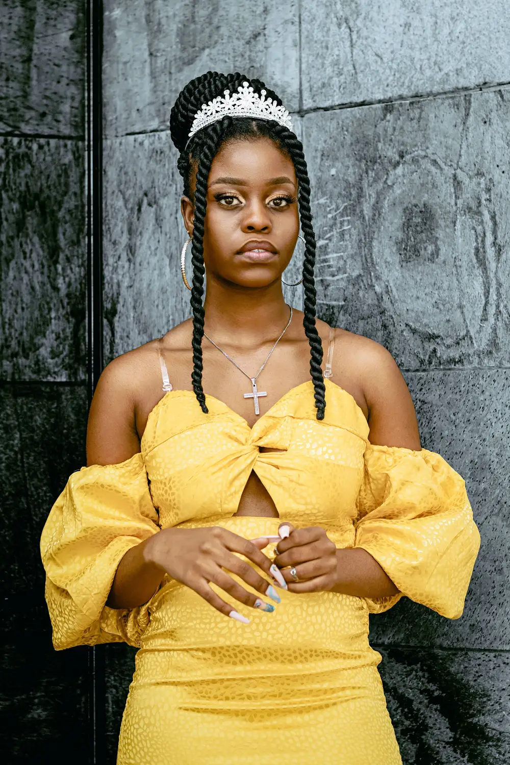 Lady in yellow with a cross pendant