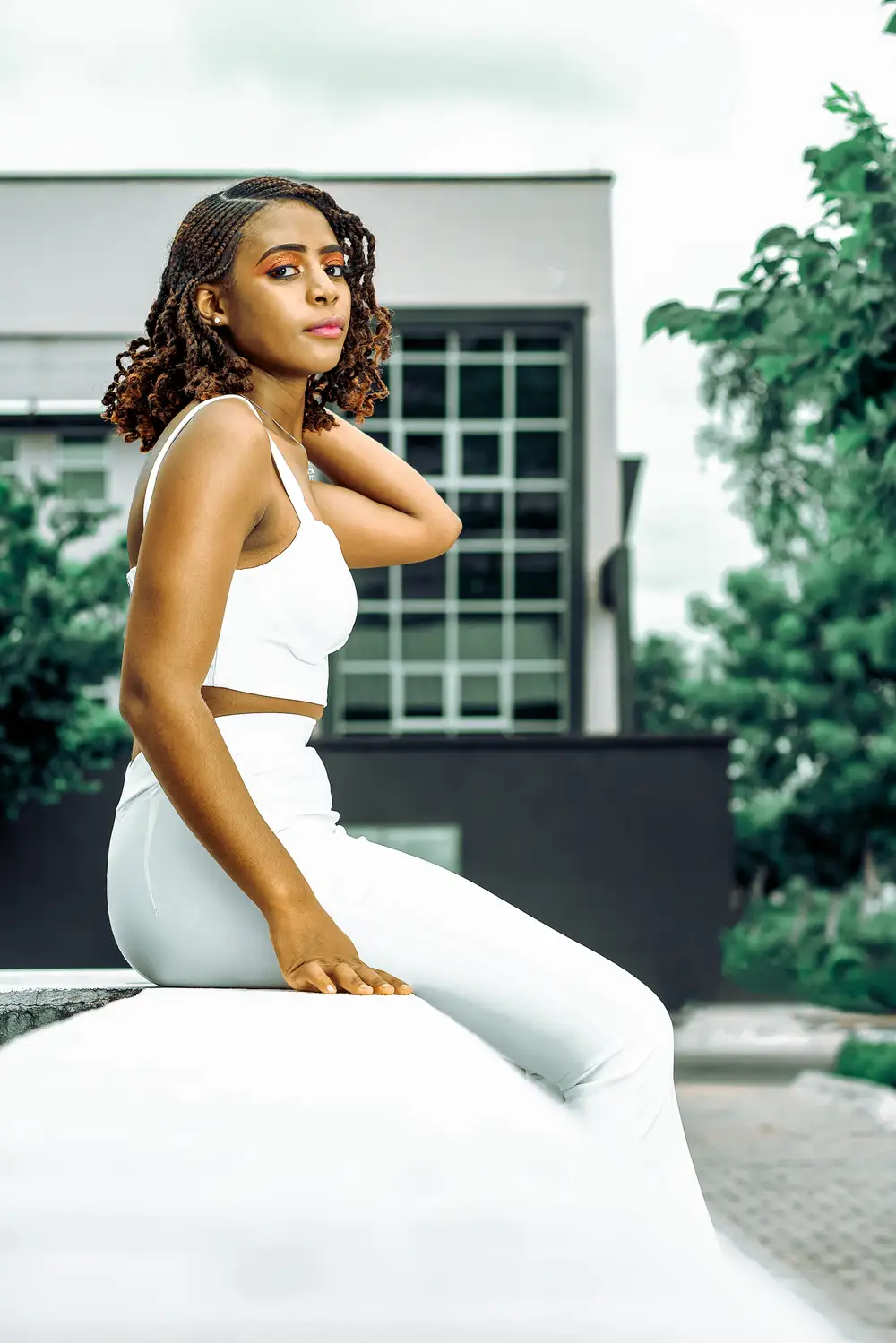 Pretty lady sitting on a fence