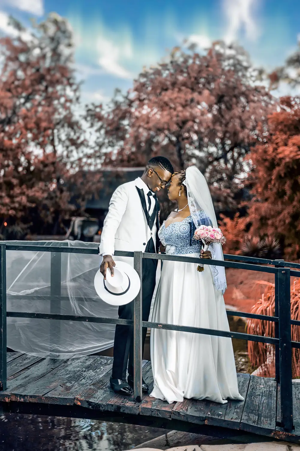 Wedded couple standing on a bridge