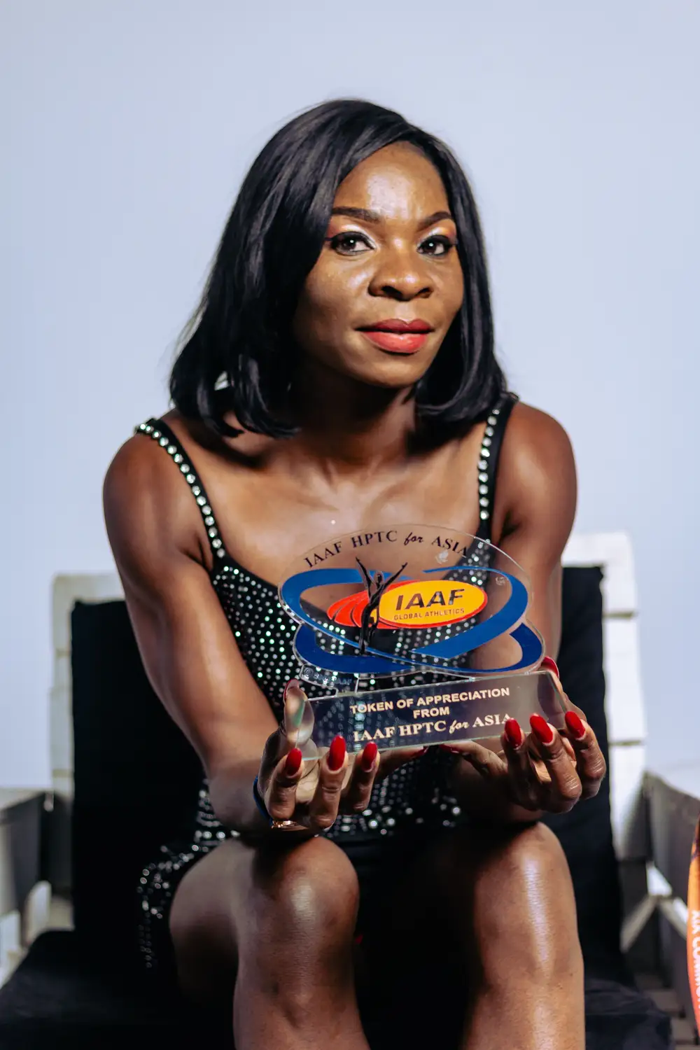 Lady holding her award