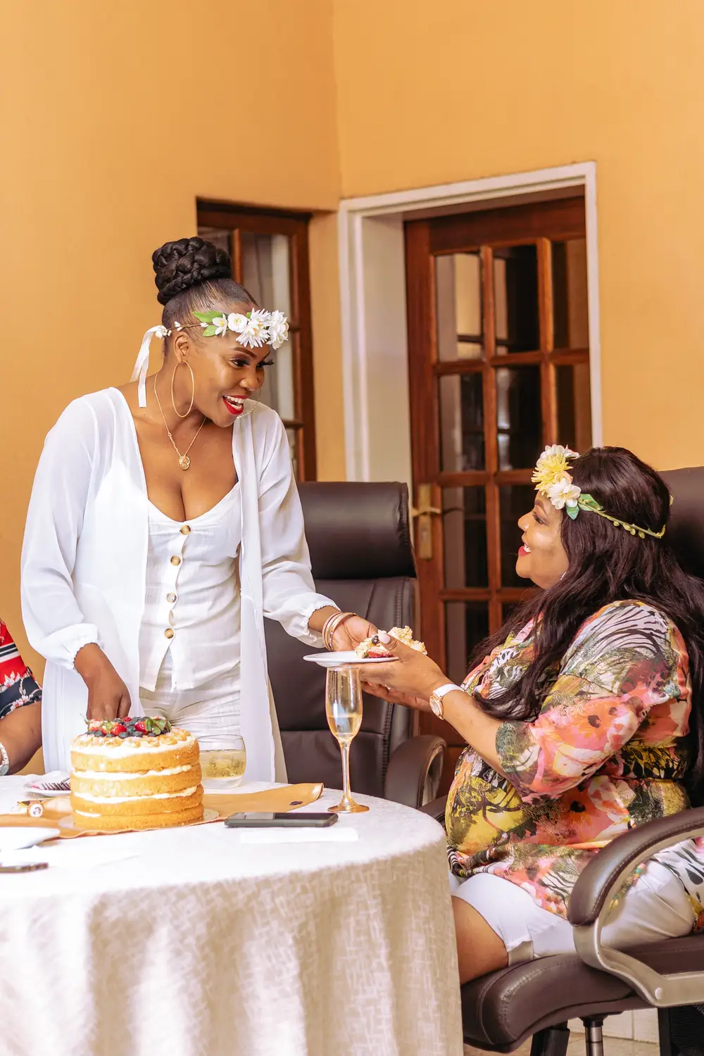 Women passing a plate of cake