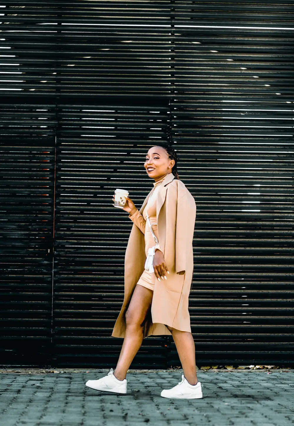 Smiling lady in front of a gate