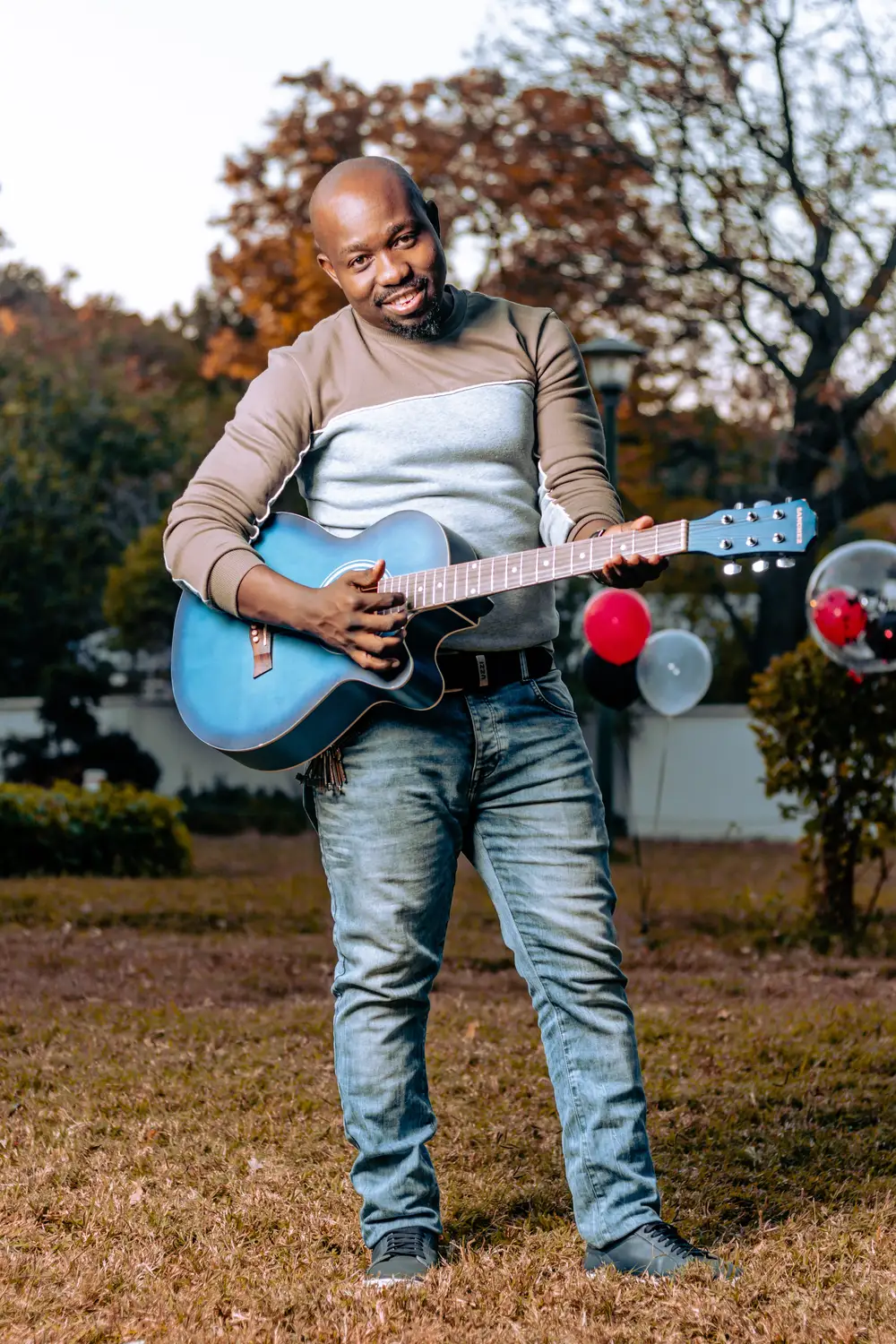 Man holding a blue guitar