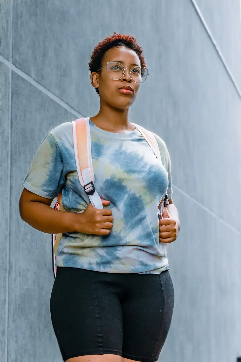 Girl on glasses with a school bag