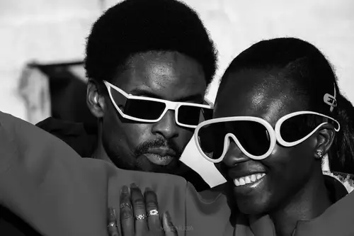 Fashionable man and woman in glasses smiling
