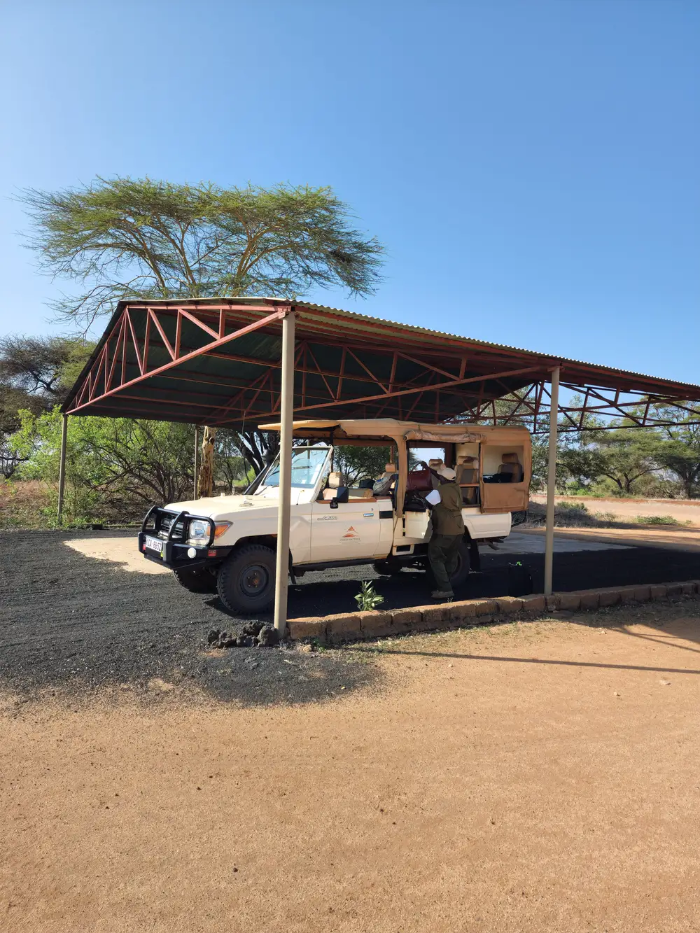 A safari van under a shade