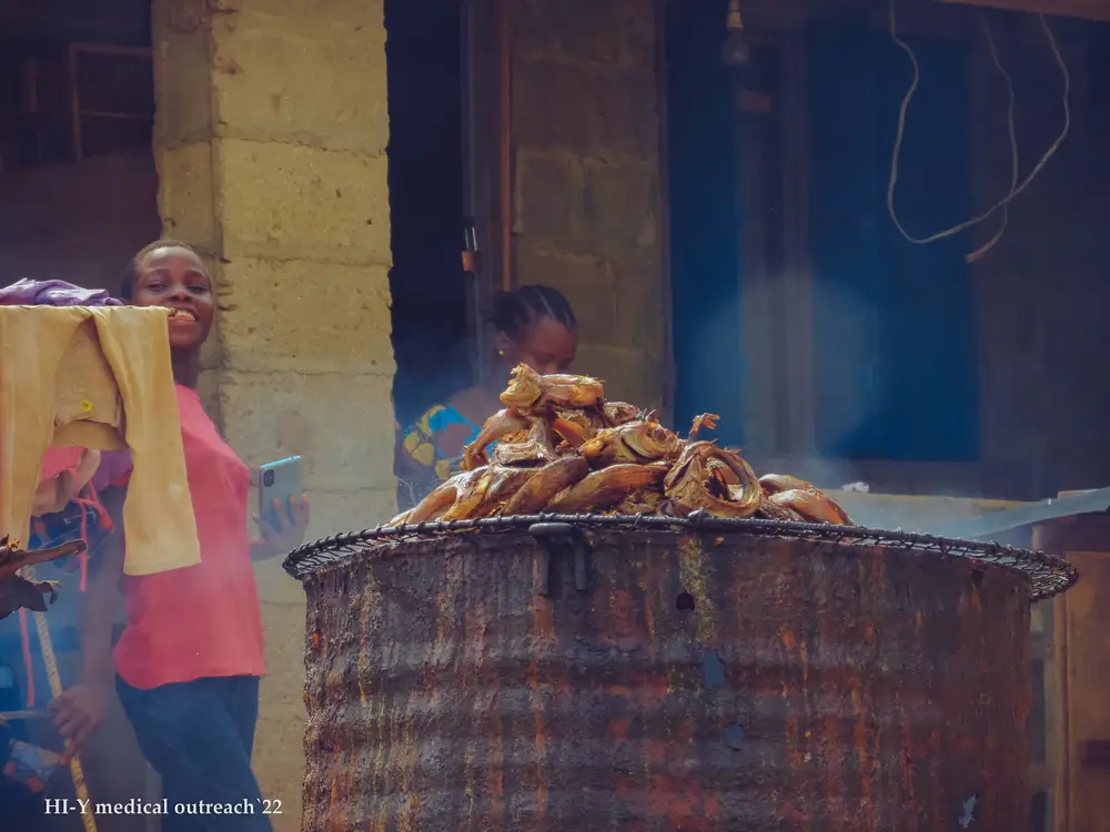 Little girl smoking fish