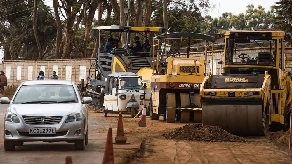 Large vehicles preparing a road for construction