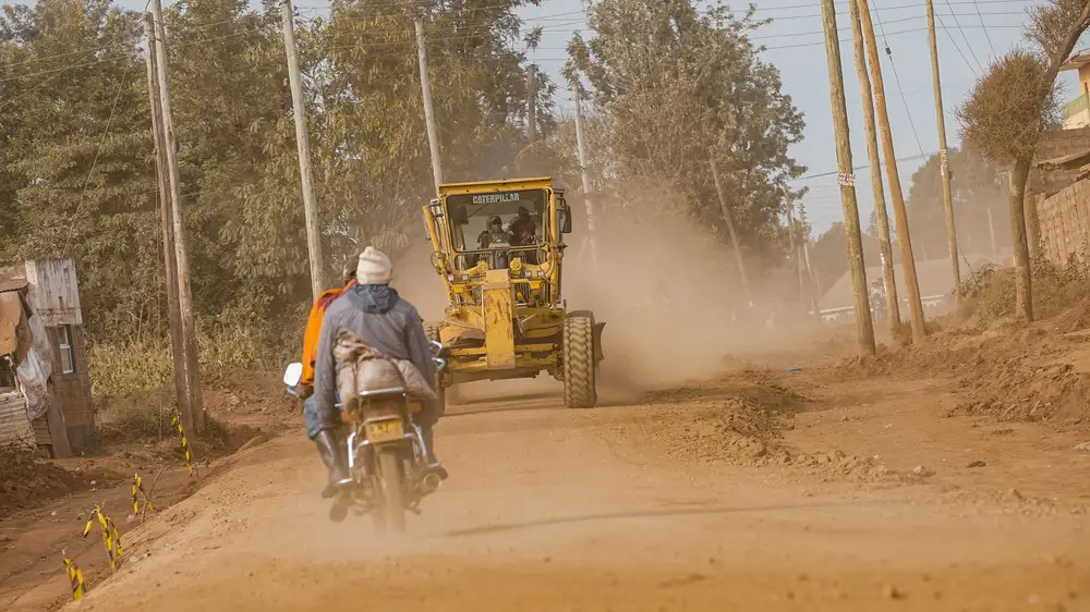 Tractor moving on a dusty road