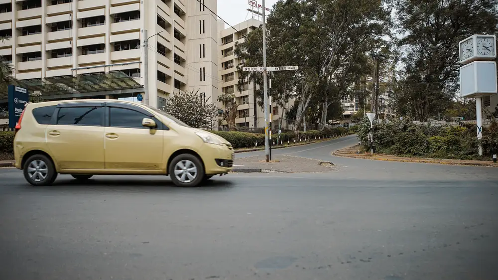Yellow private car driving on a road