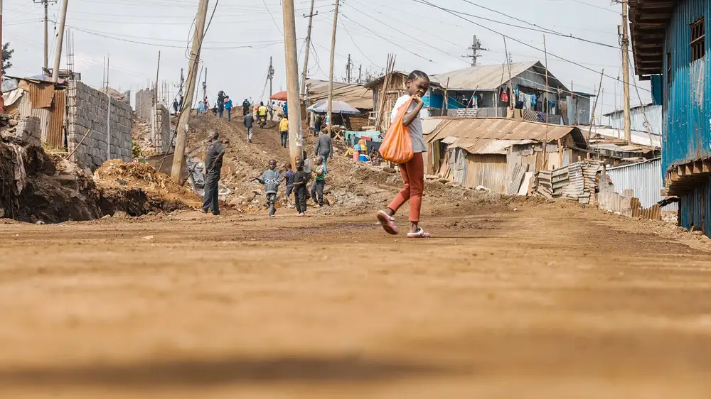 Girl walking on a road under construction