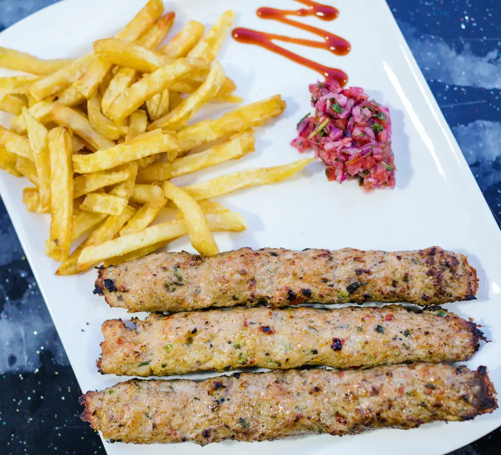 Potato fries and vegetables with rollled meat