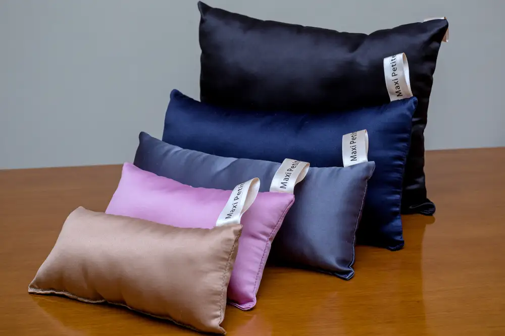 Silk pillows of different sizes and colors