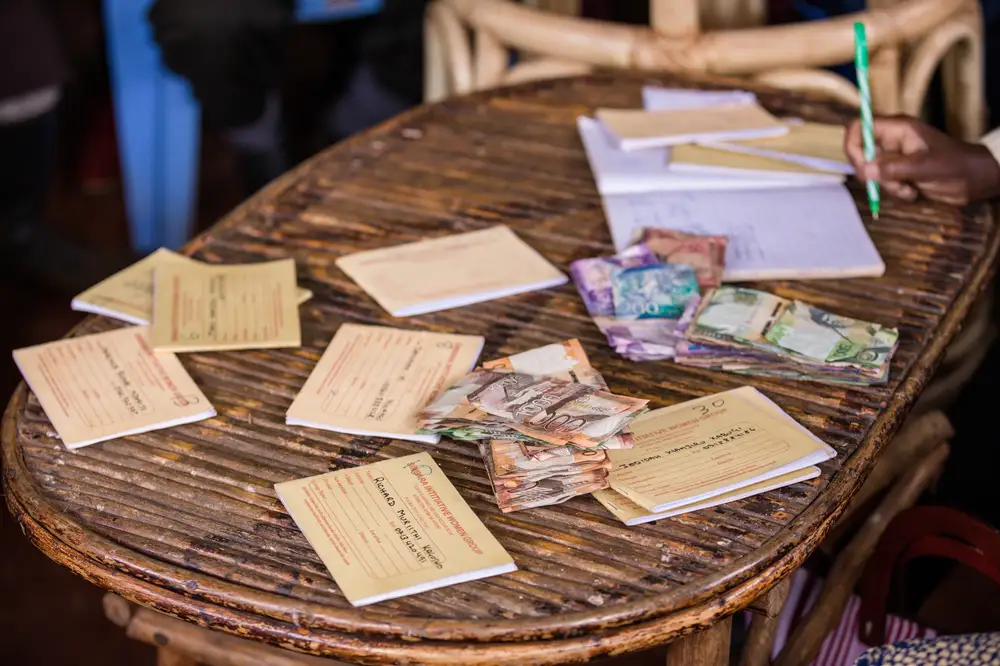 Medical data cards and money bills on a wooden table
