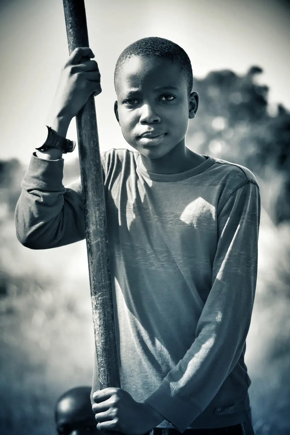 young boy holding a pole