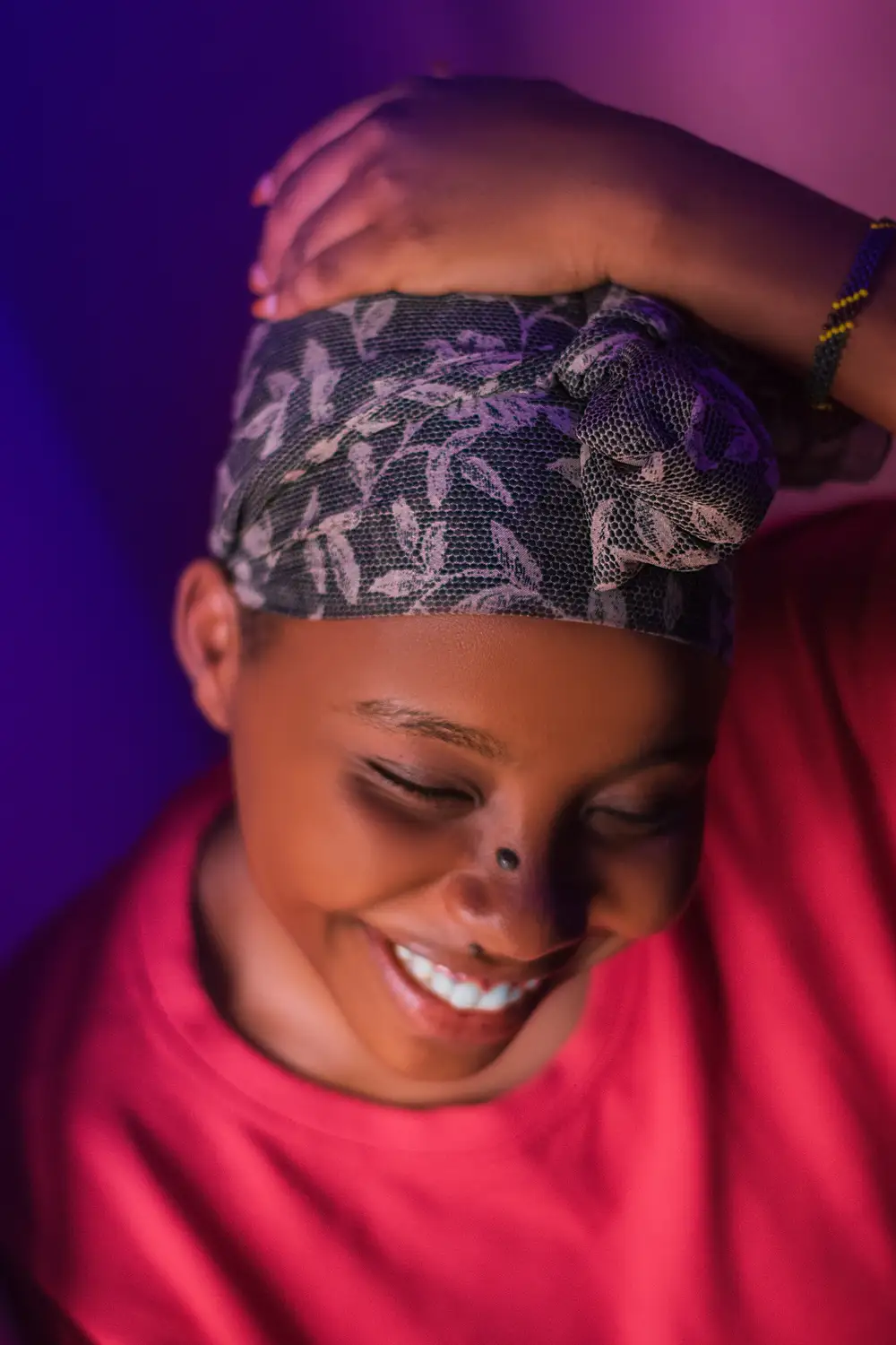 woman with her hands on her head while smiling
