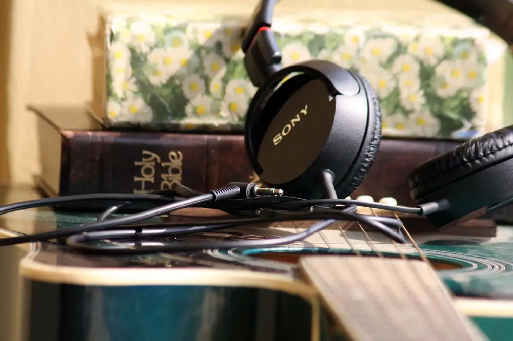 Headset and Books on a guitar