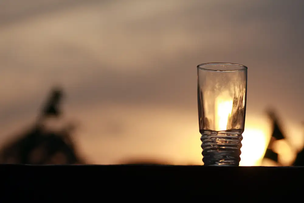 Glass cup facing sunset