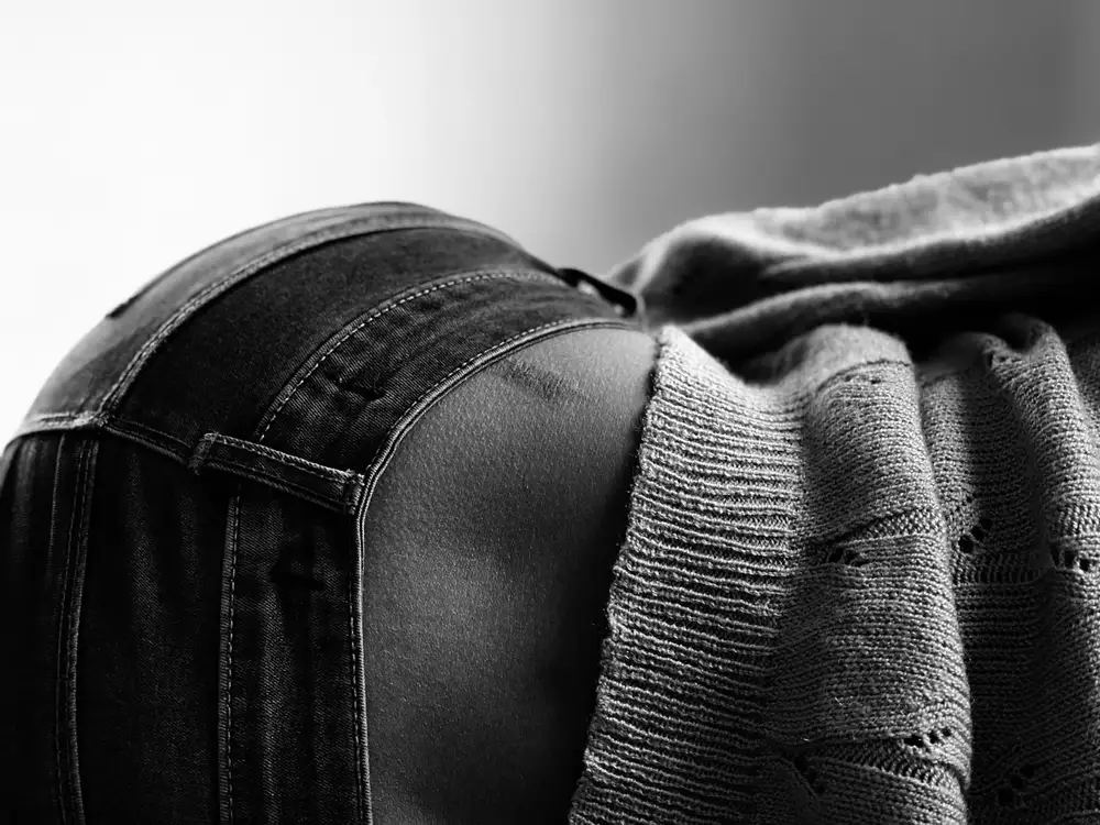 back of a woman in jeans laying down