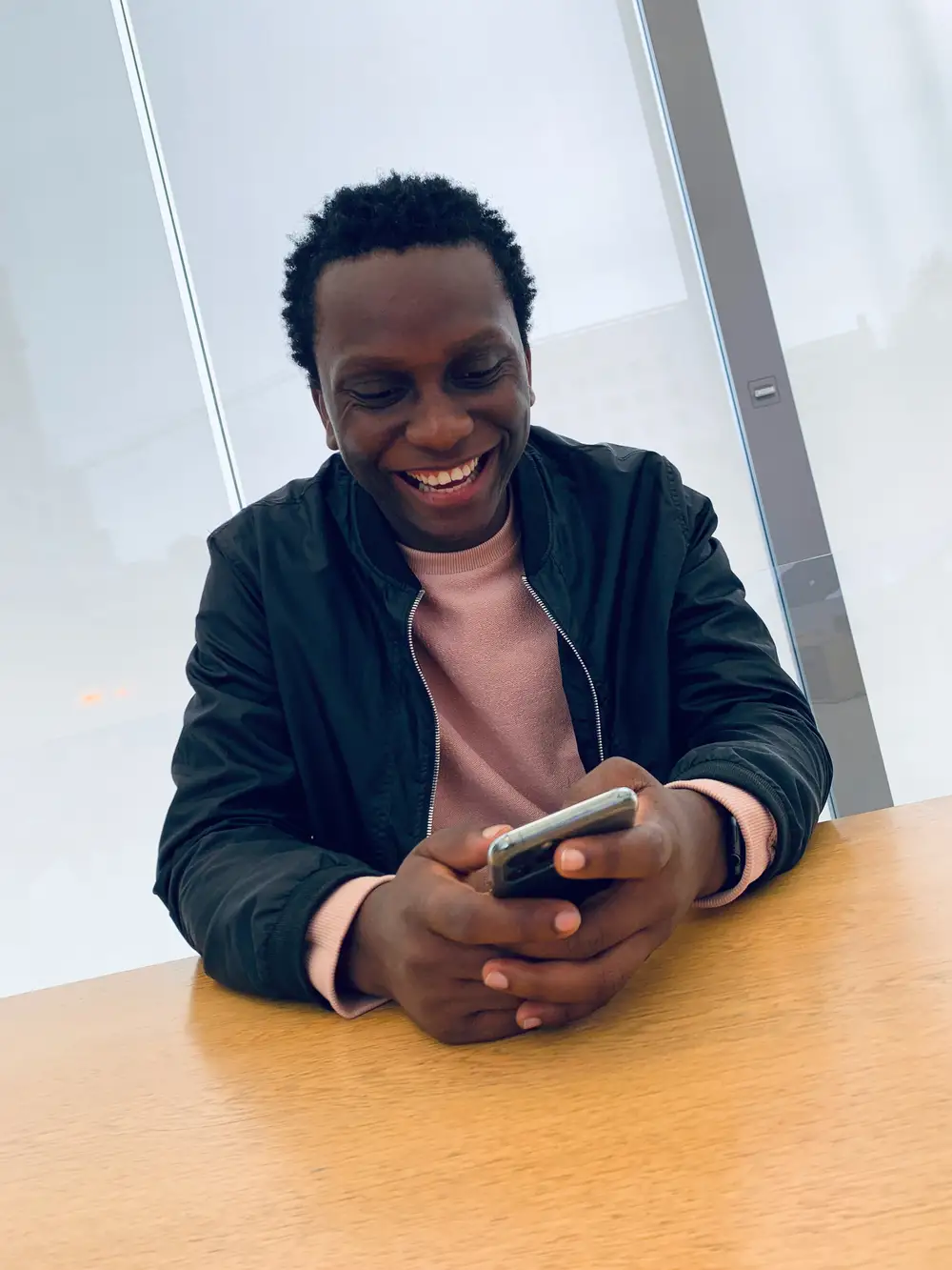 Young man laughing on his phone