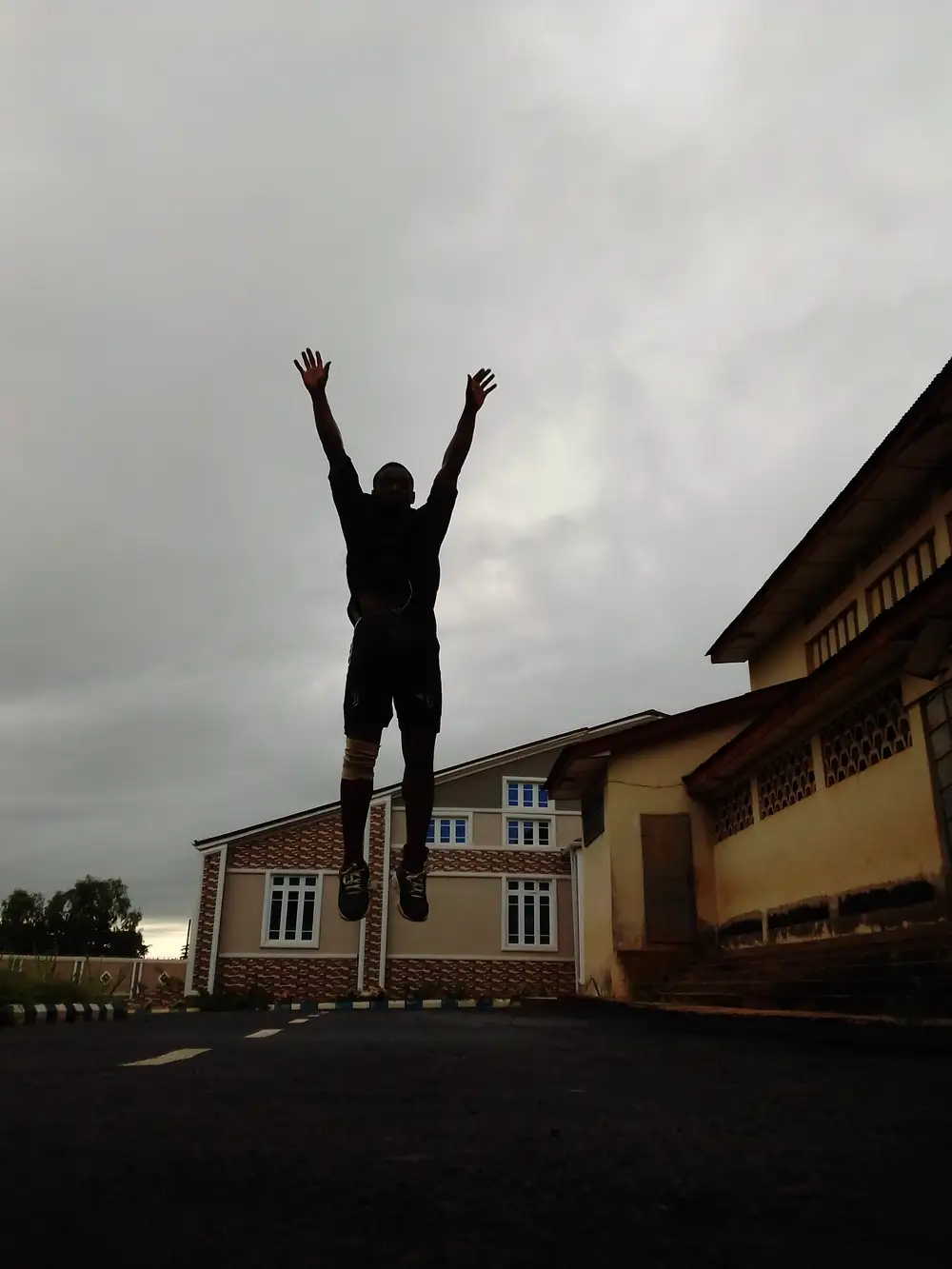 A Man jumping with hands raised