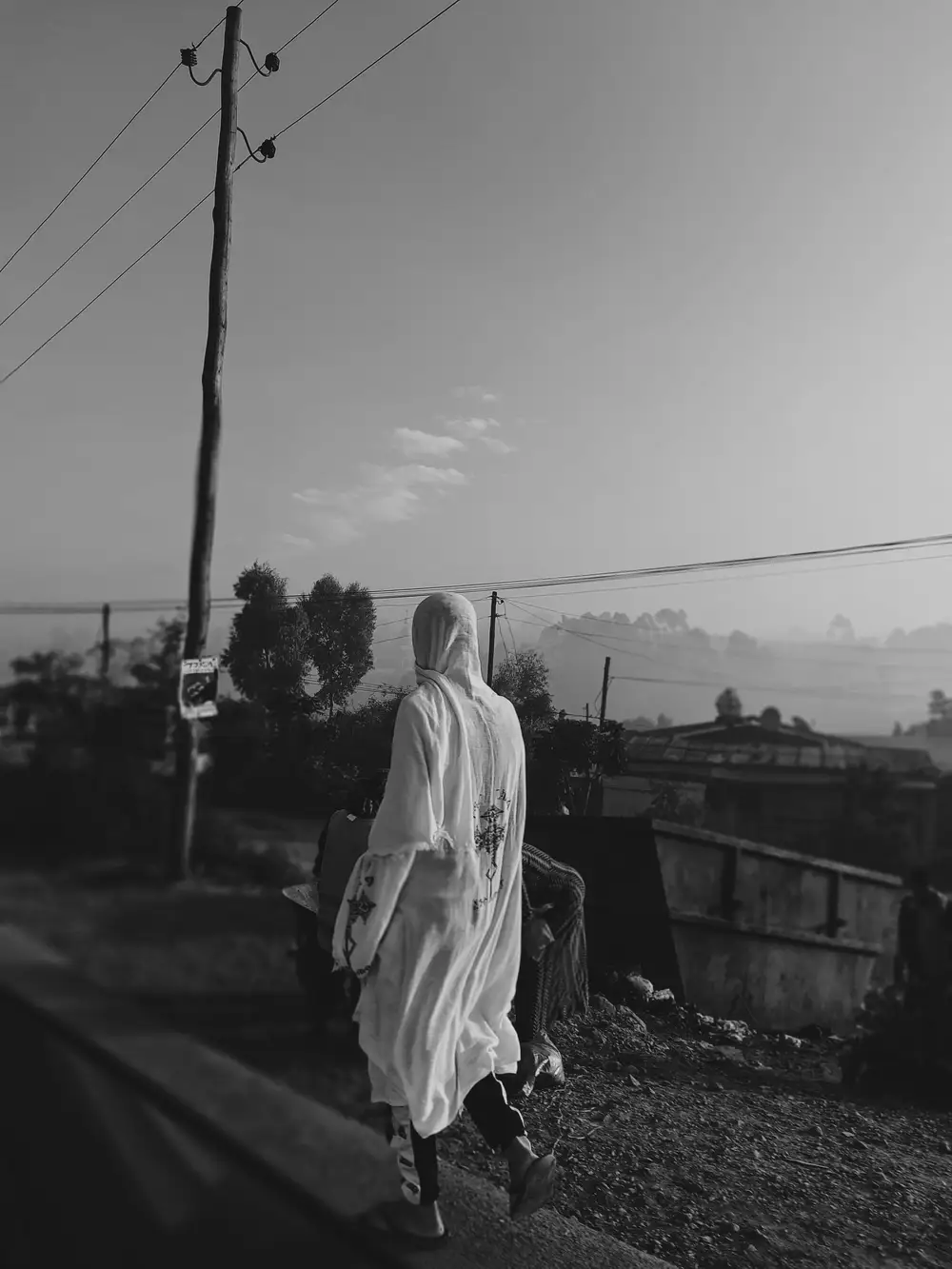 Person in traditional attire walking on the road