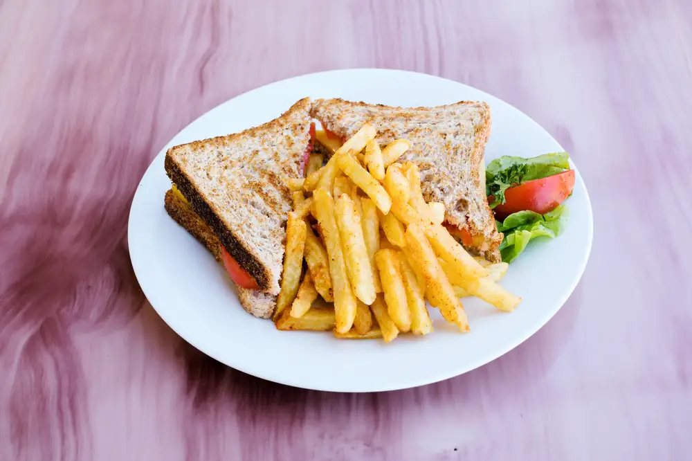 A plate of sandwich and chips