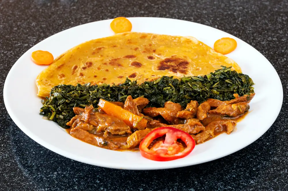 Chapati and vegetables with sauced sliced meats