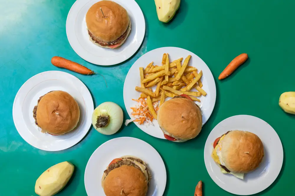 Hamburgers and potatoes fries on plates