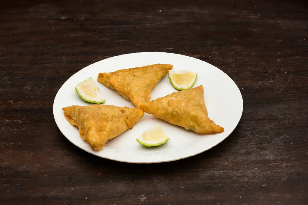 Three pieces of samosa on a plate