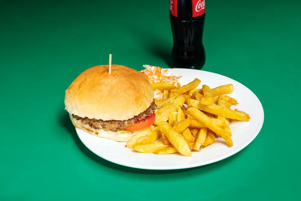 Hamburger and chips with a bottle of soda