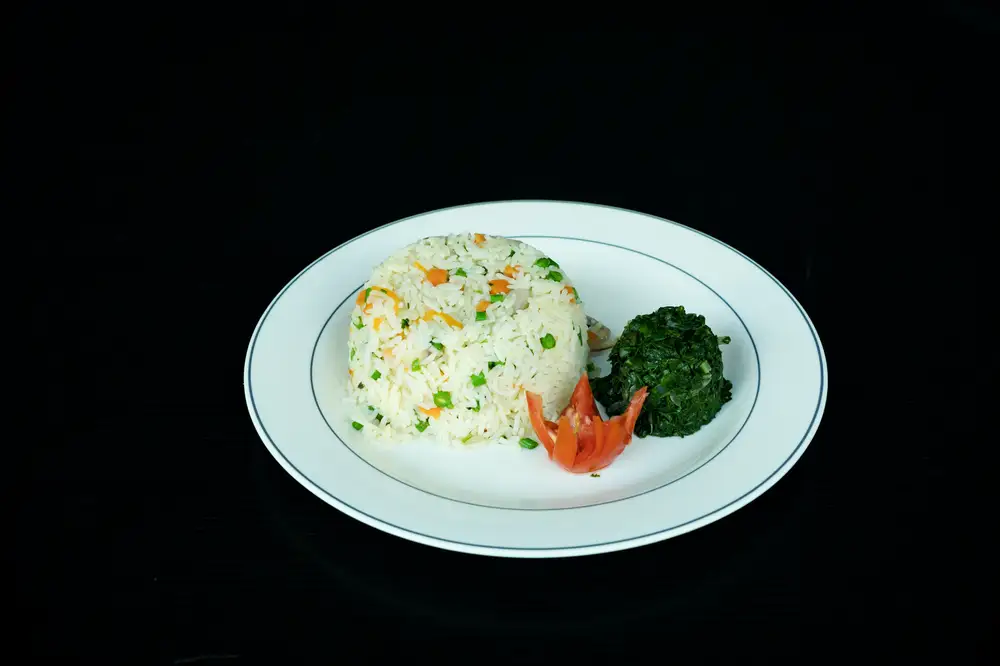 Boiled white rice and vegetables on a plate