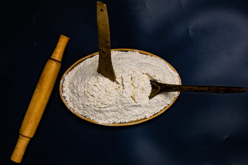 Plate of flour and baking tools on a table