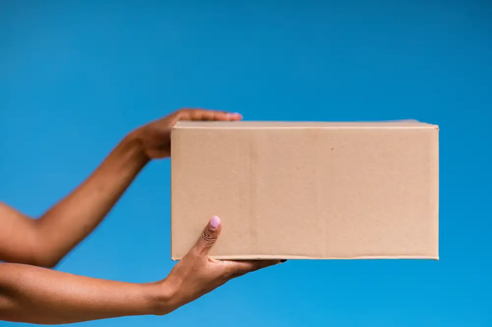 Woman holding a brown box