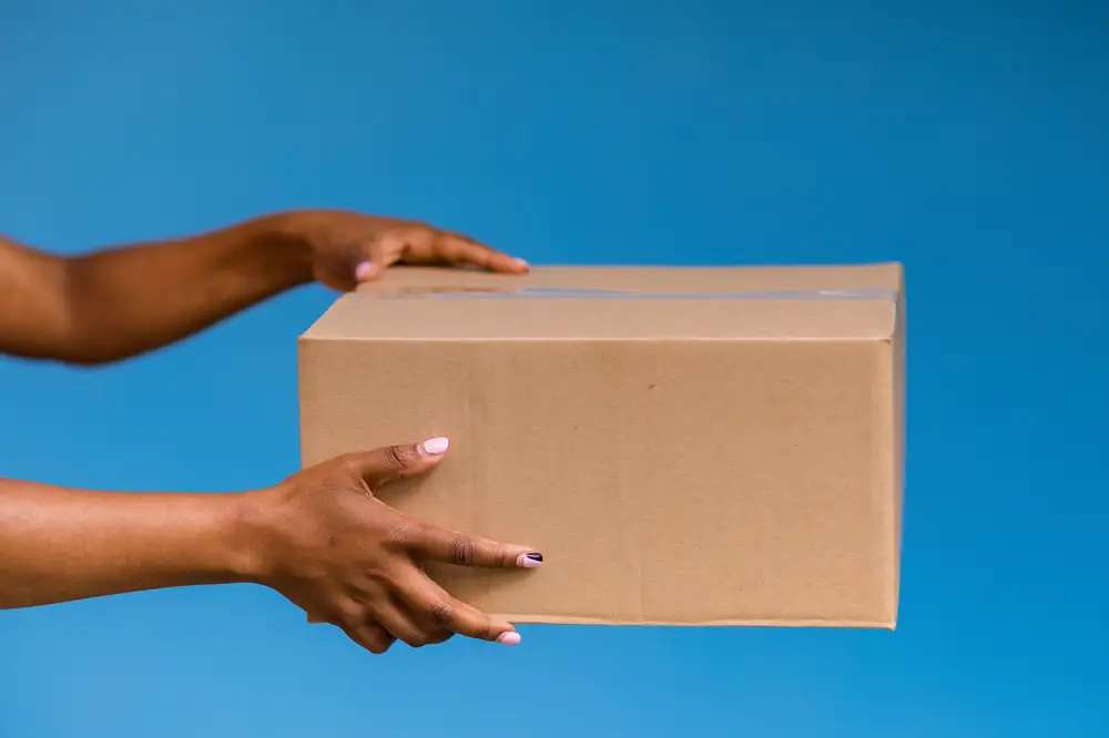 Woman holding a brown box