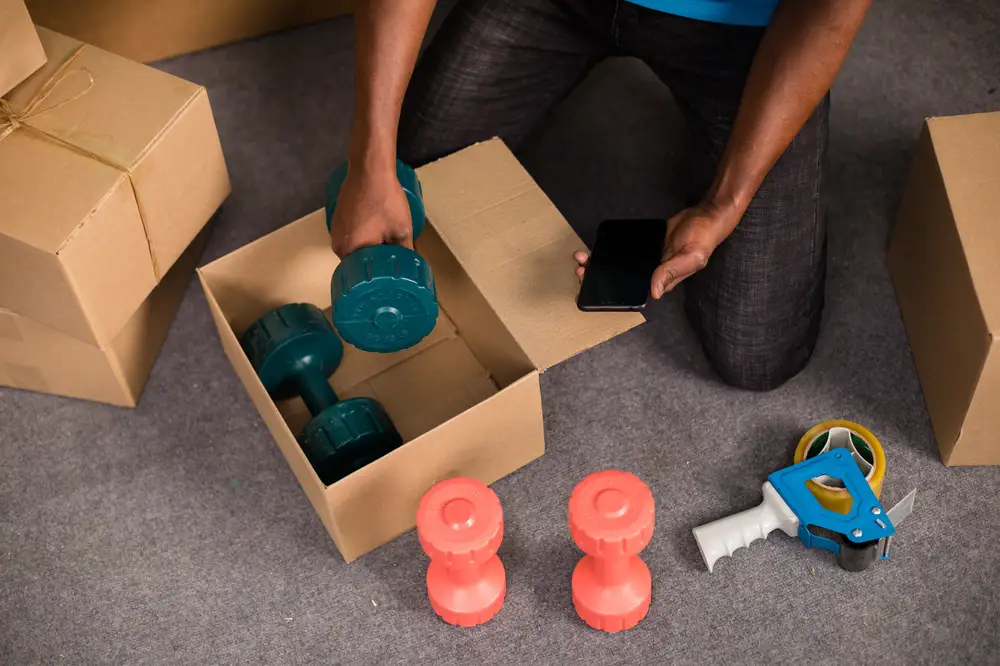Man picking dumbbell from a box
