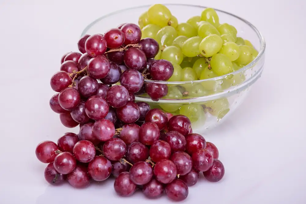 Green grapes in a bowl with red grapes