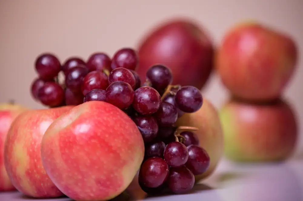 Closeup photo of red grapes and apples