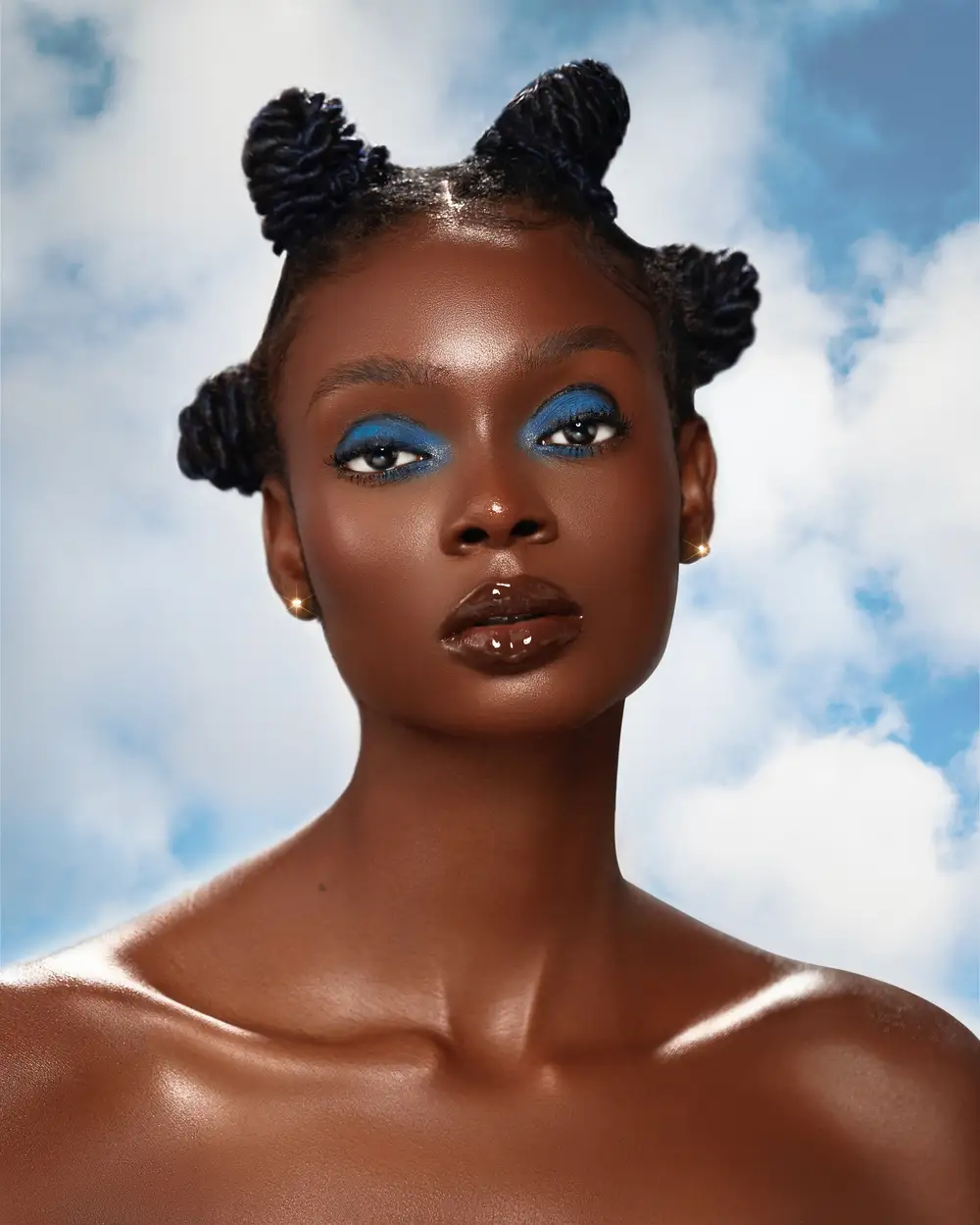 Picture of a model with heavy makeup and heads in the cloud